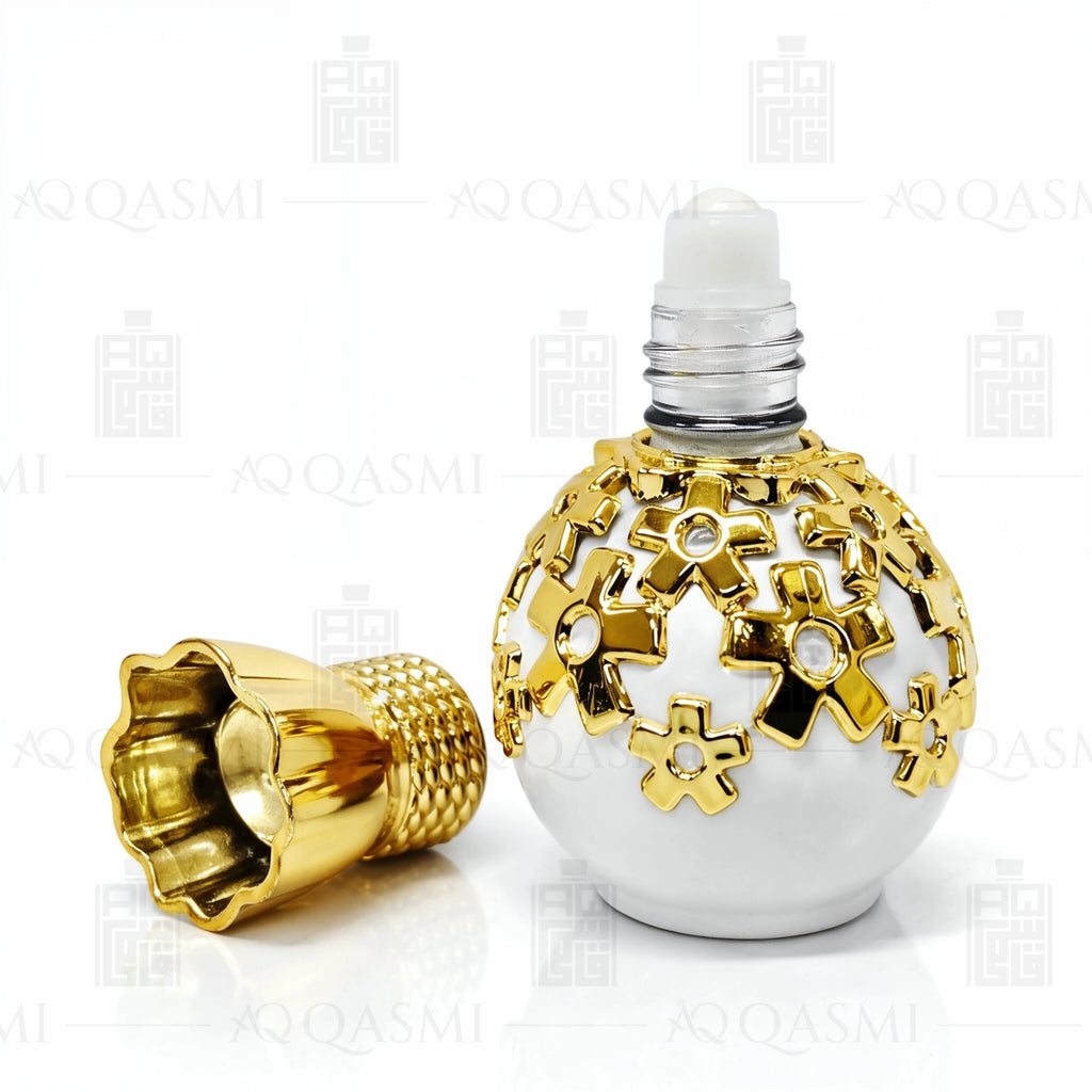 Decorative perfume bottle with gold and white design on a white background