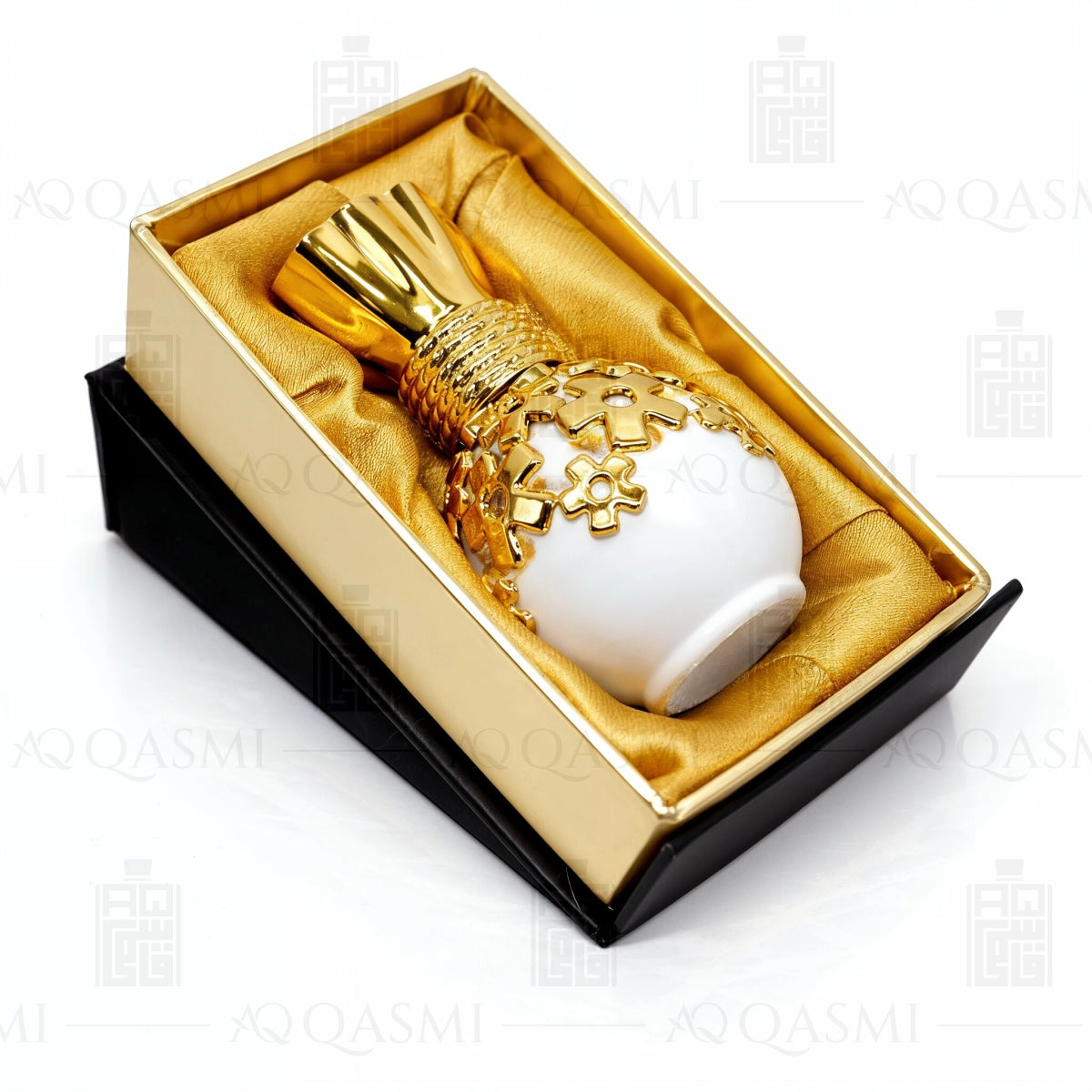 White and gold perfume bottle in a decorative box on a white background