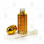 Gold and amber glass bottle with intricate design on a white background. 12ML