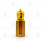 Gold and amber glass bottle with intricate design on a white background. 12ML